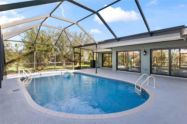 outdoor pool with a lanai and a patio area