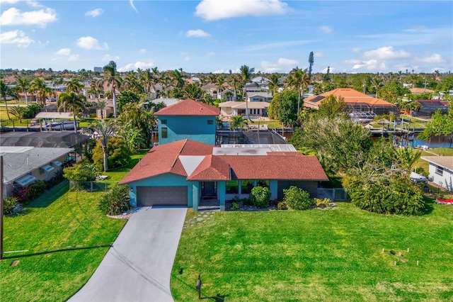 drone / aerial view featuring a residential view and a water view