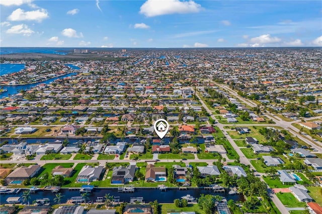 birds eye view of property with a residential view and a water view