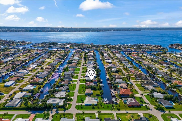 birds eye view of property with a water view and a residential view