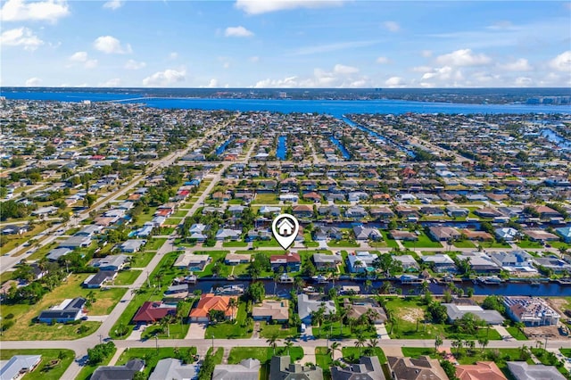 drone / aerial view with a water view and a residential view