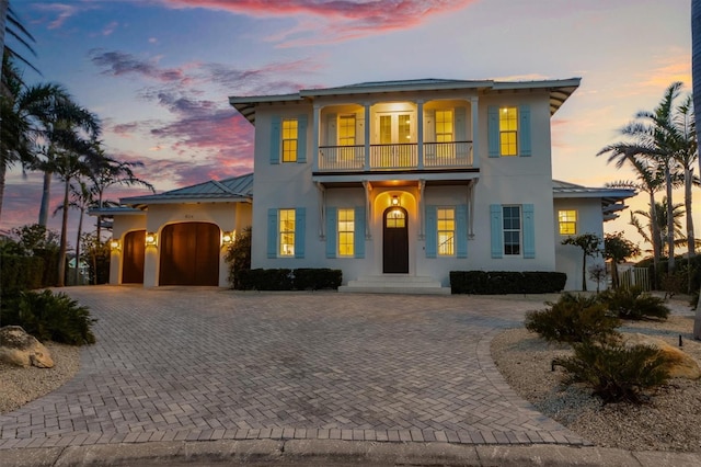 view of front of home featuring a garage and a balcony