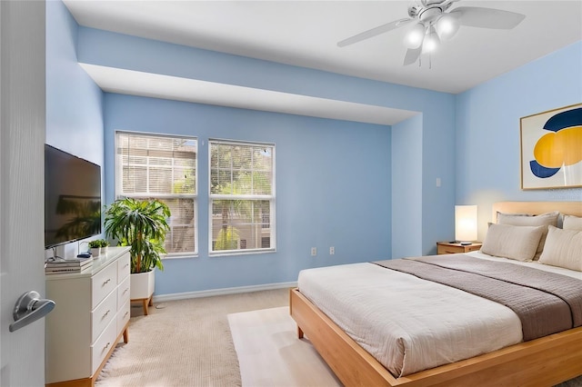7632 Plantation Cir, Bradenton, FL 34201 - bedroom with baseboards, a ceiling fan, and light colored carpet