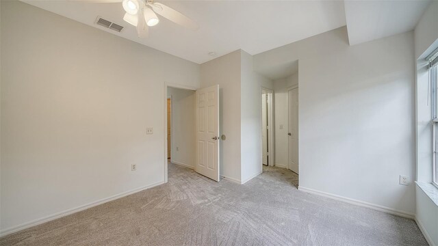 7632 Plantation Cir, Bradenton, FL 34201 - unfurnished bedroom with a ceiling fan, light colored carpet, visible vents, and baseboards
