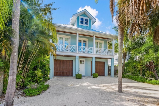 raised beach house featuring a garage