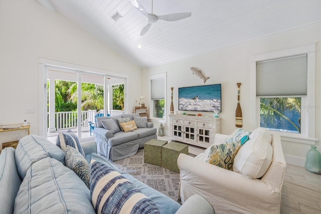 living room with high vaulted ceiling, ceiling fan, and light wood-type flooring