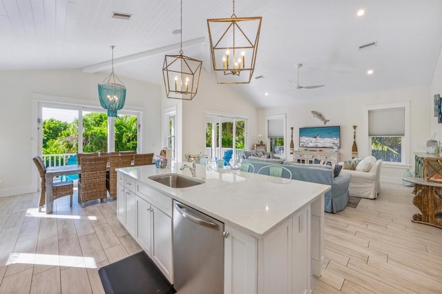 kitchen featuring sink, stainless steel dishwasher, an island with sink, pendant lighting, and white cabinets