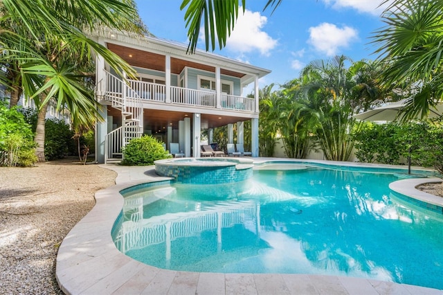 view of swimming pool featuring an in ground hot tub