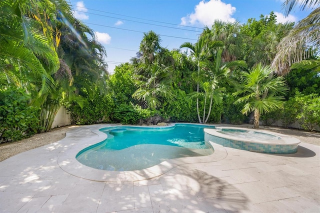 view of swimming pool featuring an in ground hot tub and a patio