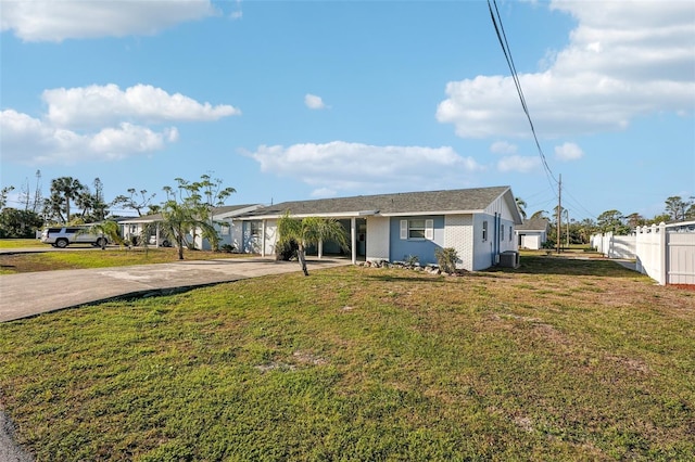 ranch-style house featuring central AC unit and a front lawn