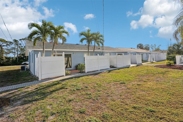 back of property with a lawn