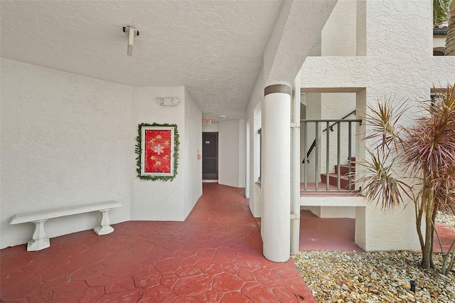 hallway featuring a textured ceiling