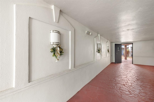 hallway with a textured ceiling