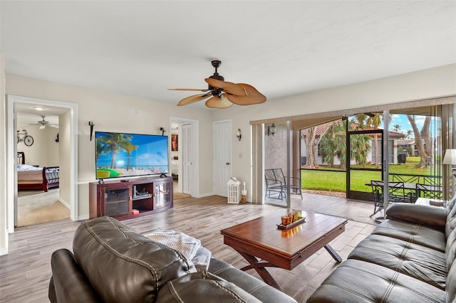 living room featuring ceiling fan and light hardwood / wood-style flooring