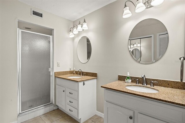 bathroom featuring walk in shower, tile patterned floors, and vanity