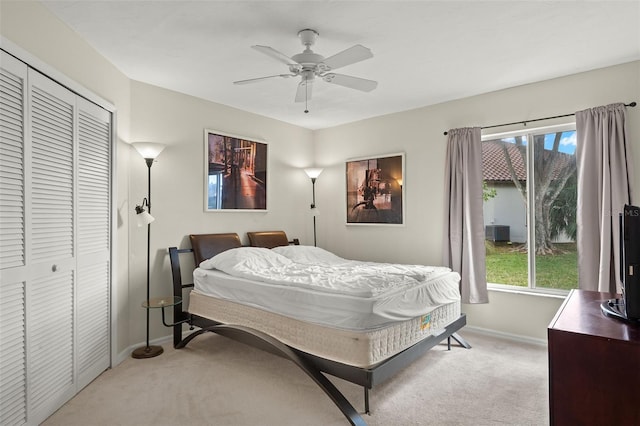 carpeted bedroom featuring a closet and ceiling fan