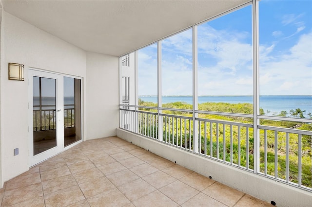 unfurnished sunroom with a water view and a healthy amount of sunlight