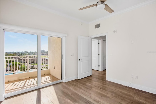 unfurnished room with hardwood / wood-style flooring, ornamental molding, and ceiling fan