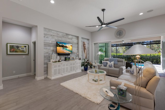 living room with ceiling fan, light hardwood / wood-style floors, and a healthy amount of sunlight