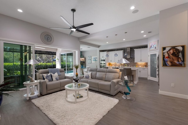 living room with dark hardwood / wood-style floors and ceiling fan