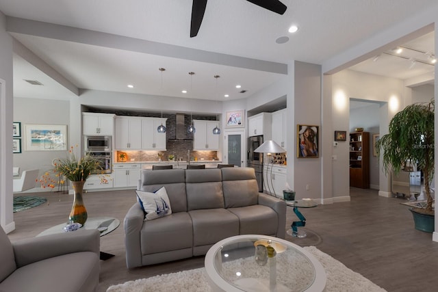 living room featuring wood-type flooring and ceiling fan