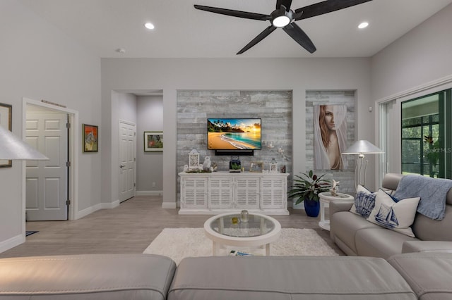 living room with ceiling fan and light wood-type flooring