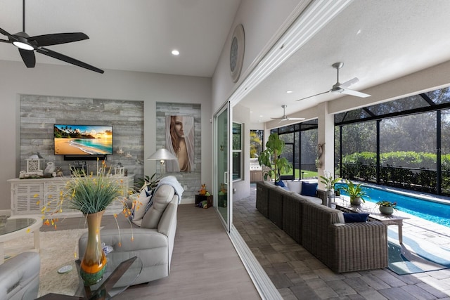 interior space with an outdoor living space, a lanai, and ceiling fan