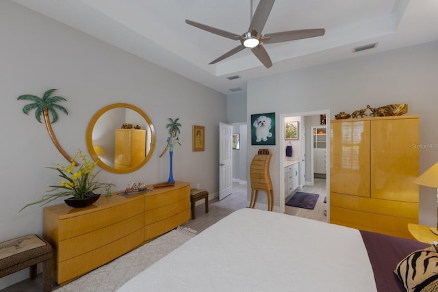 bedroom with a raised ceiling and ceiling fan