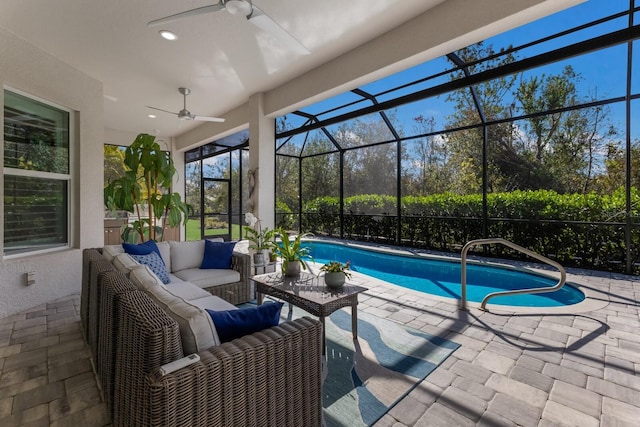 view of pool featuring an outdoor living space, a patio, ceiling fan, and glass enclosure