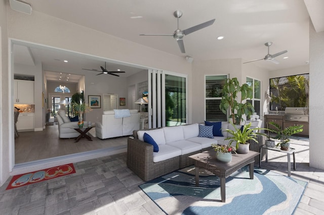 view of patio featuring ceiling fan, an outdoor kitchen, a grill, and outdoor lounge area