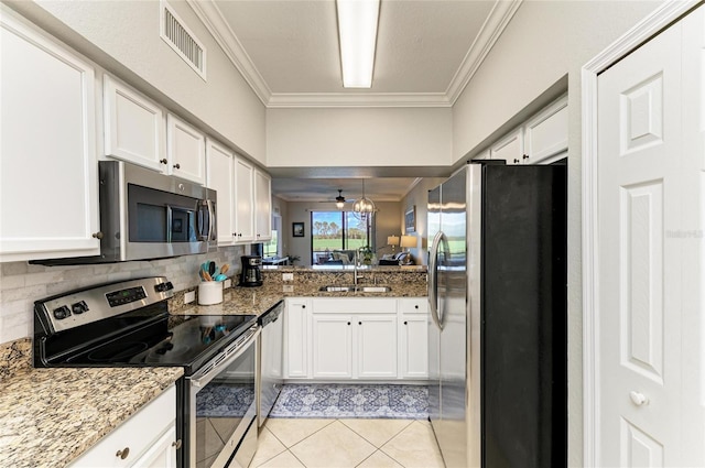 kitchen with white cabinetry, visible vents, appliances with stainless steel finishes, and ornamental molding