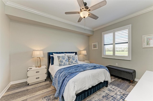 bedroom with baseboards, ornamental molding, ceiling fan, and wood finished floors