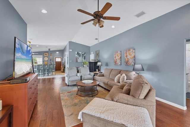 living room featuring lofted ceiling, dark hardwood / wood-style floors, and ceiling fan