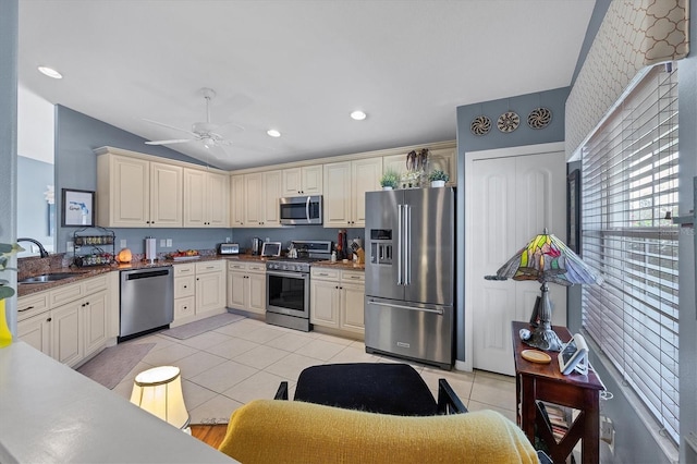 kitchen with sink, light tile patterned floors, ceiling fan, stainless steel appliances, and cream cabinetry