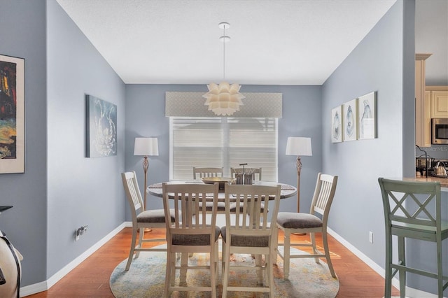 dining room with a notable chandelier and light hardwood / wood-style floors