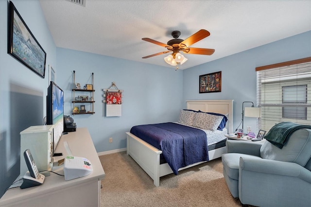 carpeted bedroom with a textured ceiling and ceiling fan