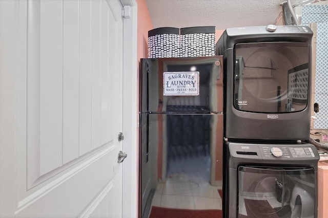 clothes washing area with stacked washer / dryer