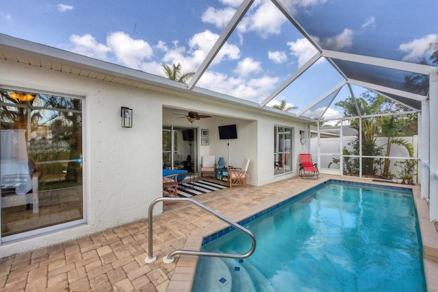 view of pool featuring a lanai, a patio area, and ceiling fan