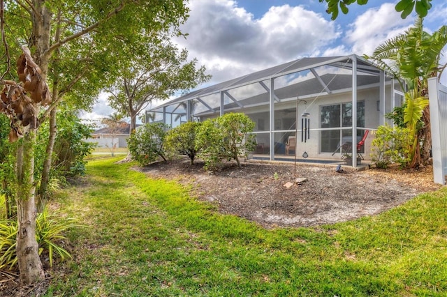 back of property featuring a yard and a lanai