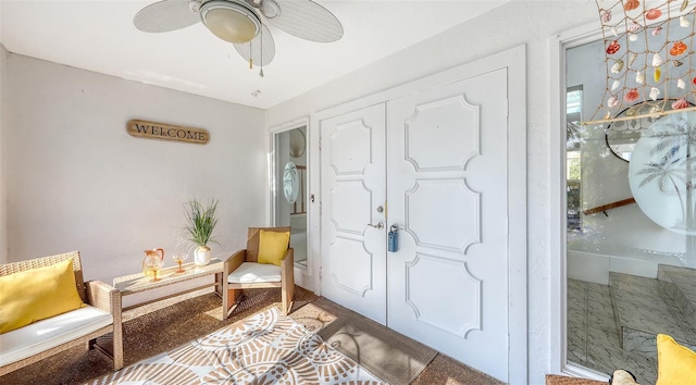 entrance foyer with ceiling fan