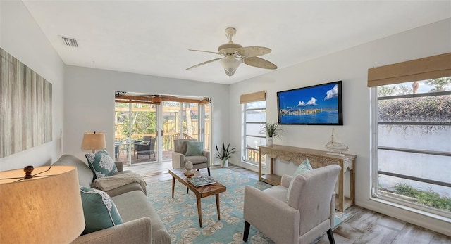 living room with ceiling fan and light hardwood / wood-style floors