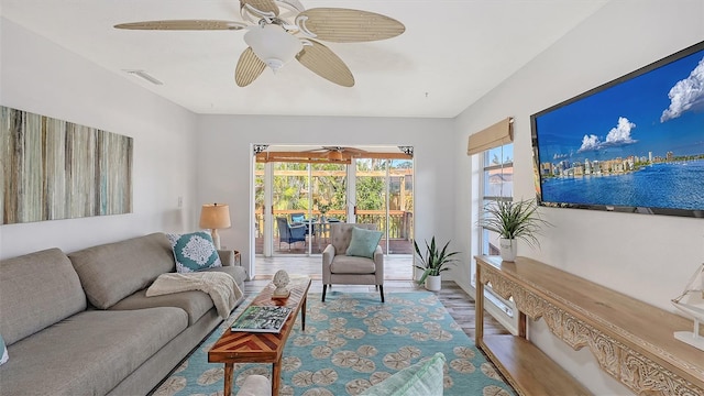 living room featuring hardwood / wood-style floors and ceiling fan