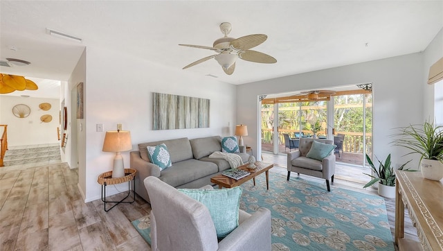 living room with ceiling fan and light wood-type flooring