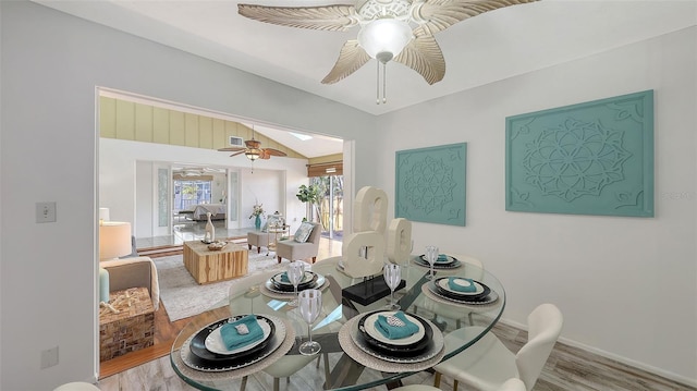 dining space with lofted ceiling, ceiling fan, and light wood-type flooring