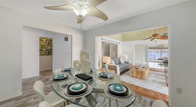 dining space featuring ceiling fan and light wood-type flooring