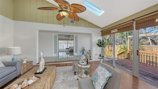 sunroom / solarium featuring ceiling fan and vaulted ceiling with skylight