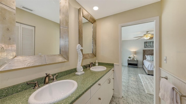 bathroom with ceiling fan and vanity