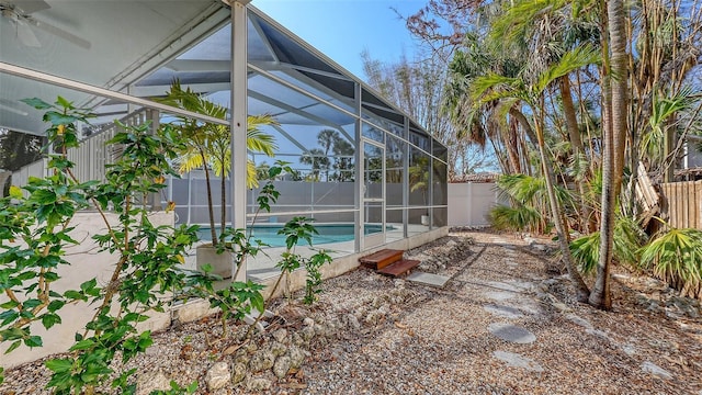 view of pool with glass enclosure