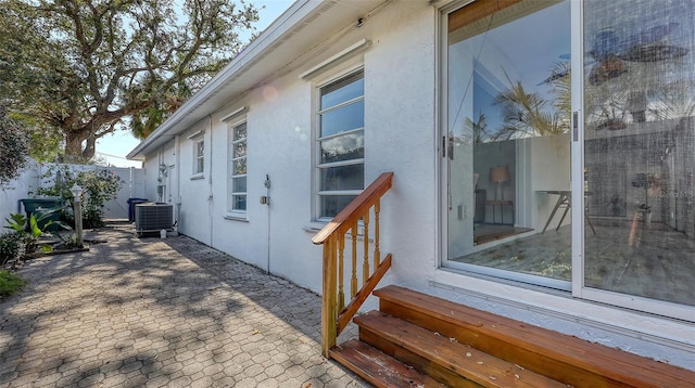 view of side of home with a patio and central AC unit