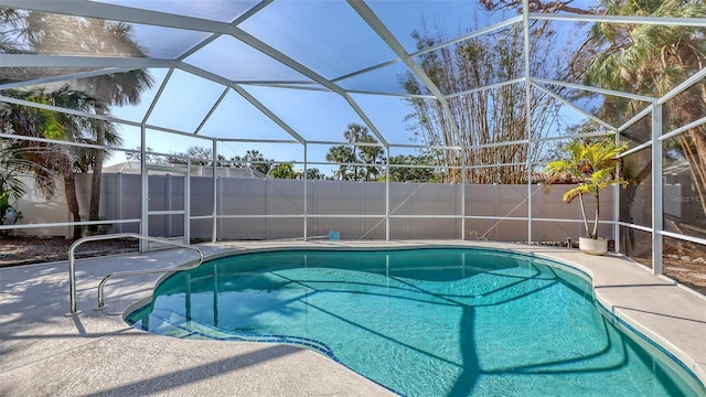 view of swimming pool featuring a lanai and a patio